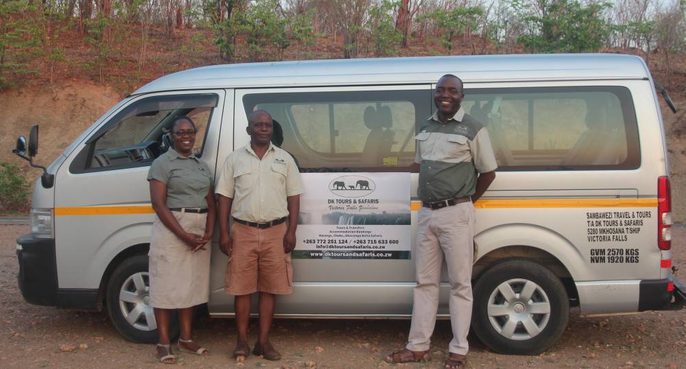 DK Tours team beside a transfer minibus