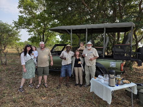 Guests and DK Tours guides beside an open safari vehicle